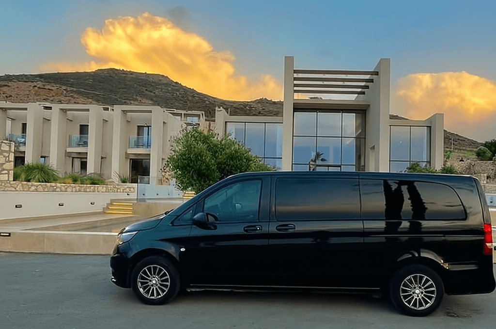 Driver loading a luxury minivan with suitcases